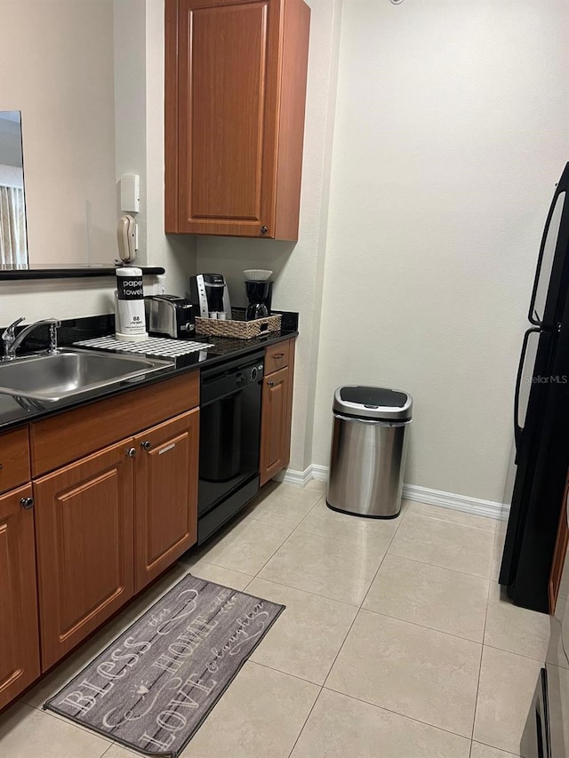 kitchen featuring sink, black appliances, and light tile patterned floors