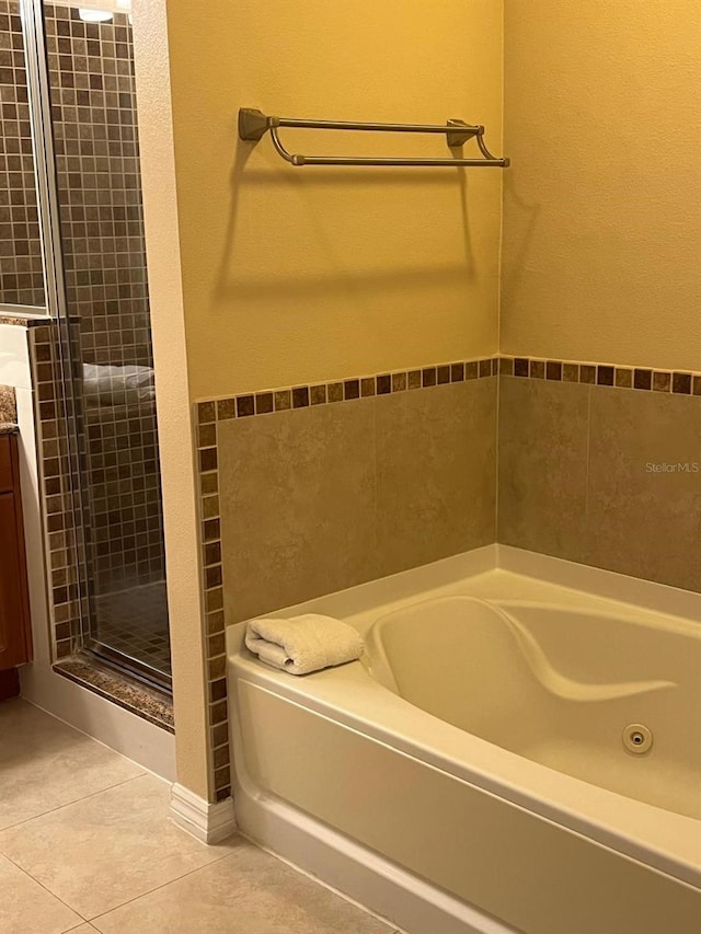 bathroom featuring vanity, shower with separate bathtub, and tile patterned floors