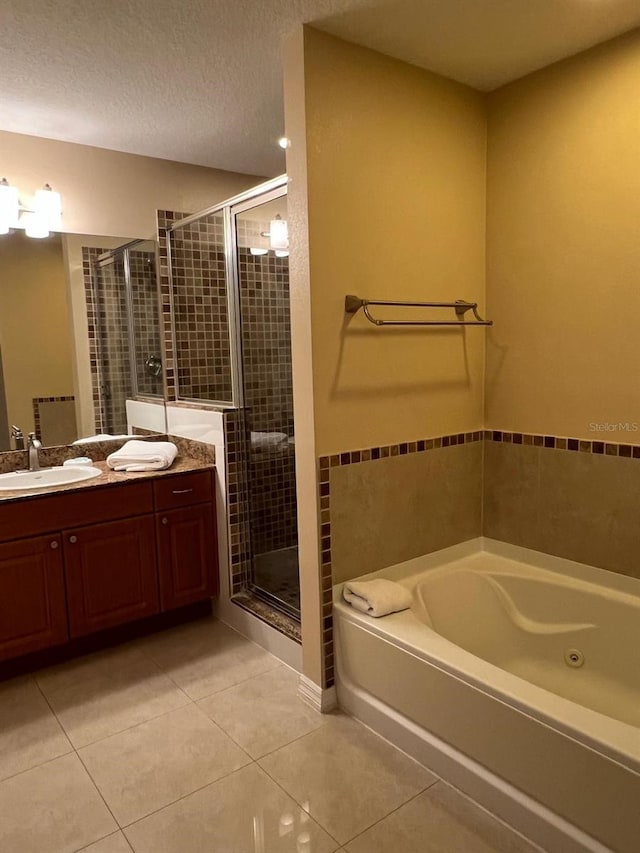 bathroom with vanity, tile patterned flooring, independent shower and bath, and a textured ceiling