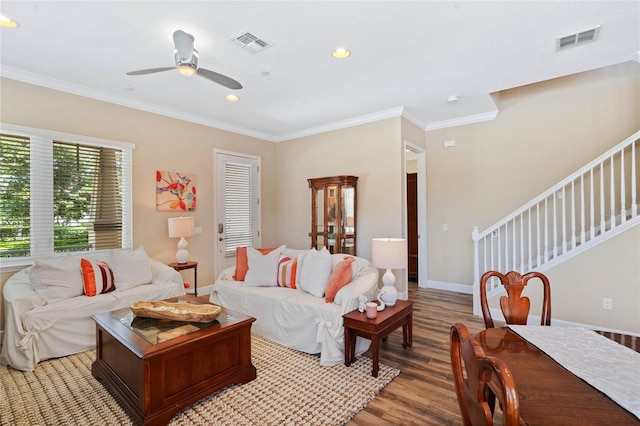 living room featuring ceiling fan, ornamental molding, and light hardwood / wood-style flooring