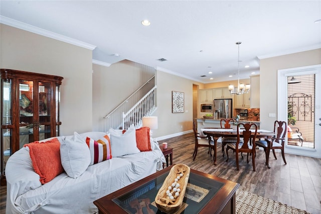 living room with ornamental molding, dark hardwood / wood-style flooring, and a chandelier