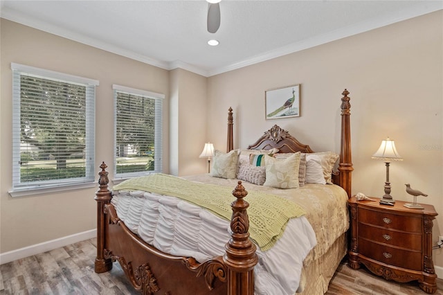 bedroom featuring ceiling fan, ornamental molding, light hardwood / wood-style floors, and multiple windows