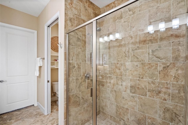 bathroom featuring an enclosed shower and toilet