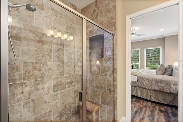 bathroom with wood-type flooring, ornamental molding, an enclosed shower, and ceiling fan