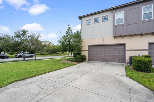 view of property exterior with a garage and a yard