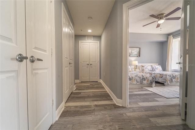 hallway with dark hardwood / wood-style floors