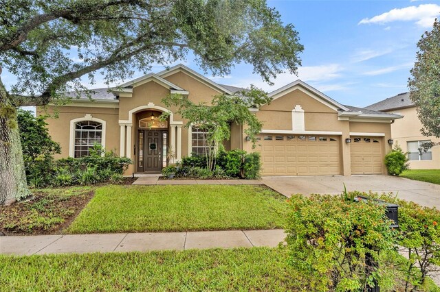 single story home with a front lawn and a garage