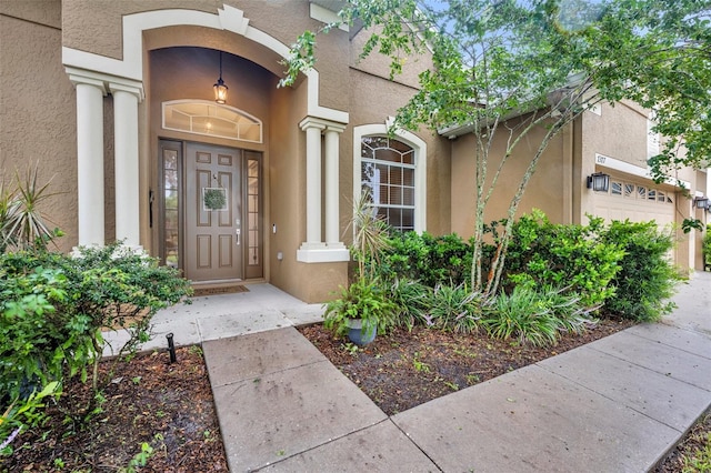 doorway to property with a garage