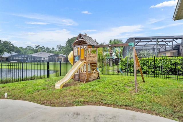 view of play area with a lawn and a water view