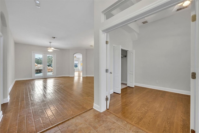 unfurnished room with french doors, light hardwood / wood-style floors, and ceiling fan