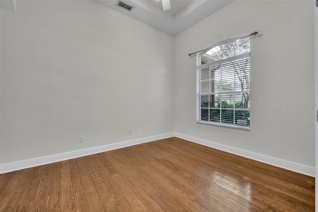 spare room with wood-type flooring