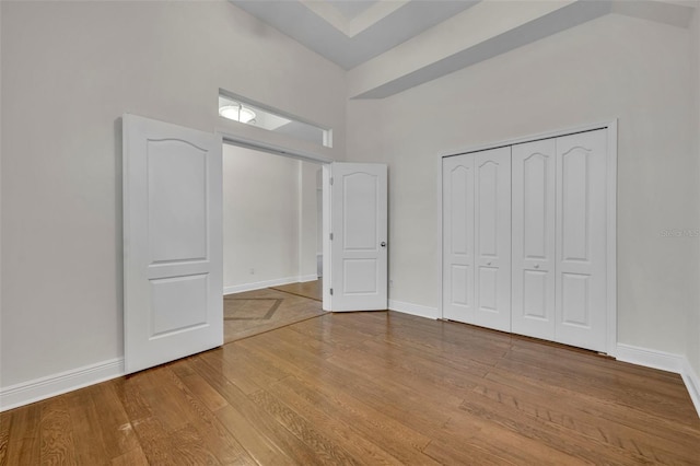 unfurnished bedroom featuring light hardwood / wood-style flooring and a closet