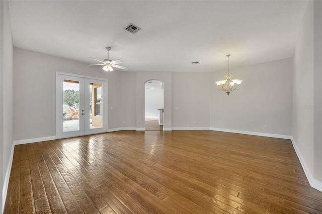 unfurnished room with french doors, hardwood / wood-style floors, and ceiling fan with notable chandelier