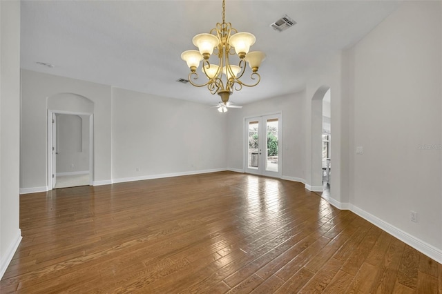 unfurnished room with dark wood-type flooring and ceiling fan with notable chandelier