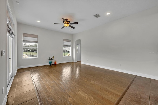 spare room featuring ceiling fan and dark hardwood / wood-style floors