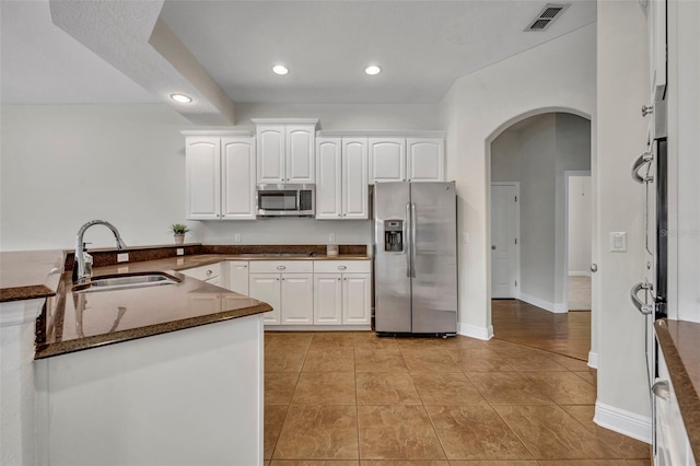 kitchen with light tile patterned flooring, white cabinetry, sink, and appliances with stainless steel finishes