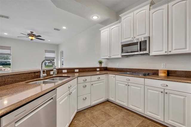 kitchen with ceiling fan, sink, white cabinetry, and stainless steel appliances