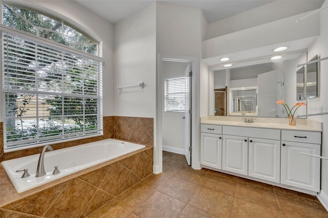 bathroom with tile patterned floors, plus walk in shower, and vanity