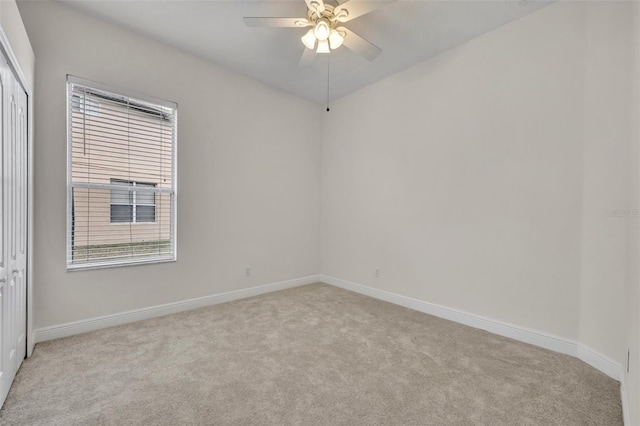 carpeted empty room with ceiling fan