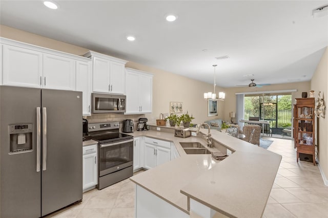 kitchen with white cabinetry, appliances with stainless steel finishes, sink, and tasteful backsplash