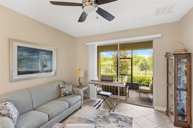 tiled living room featuring ceiling fan