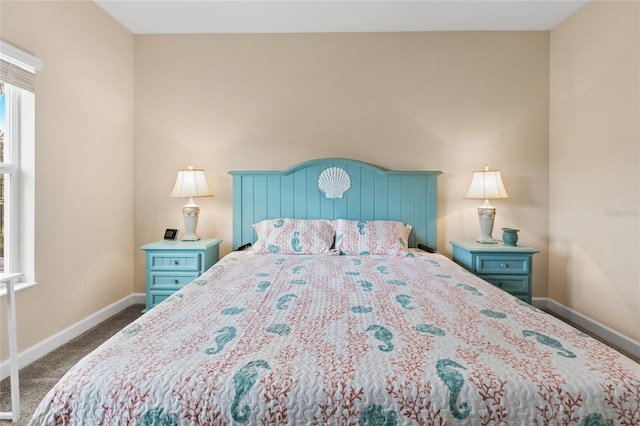 bedroom with baseboards and dark carpet