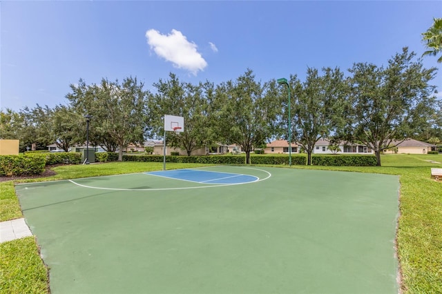 view of basketball court with a lawn and community basketball court
