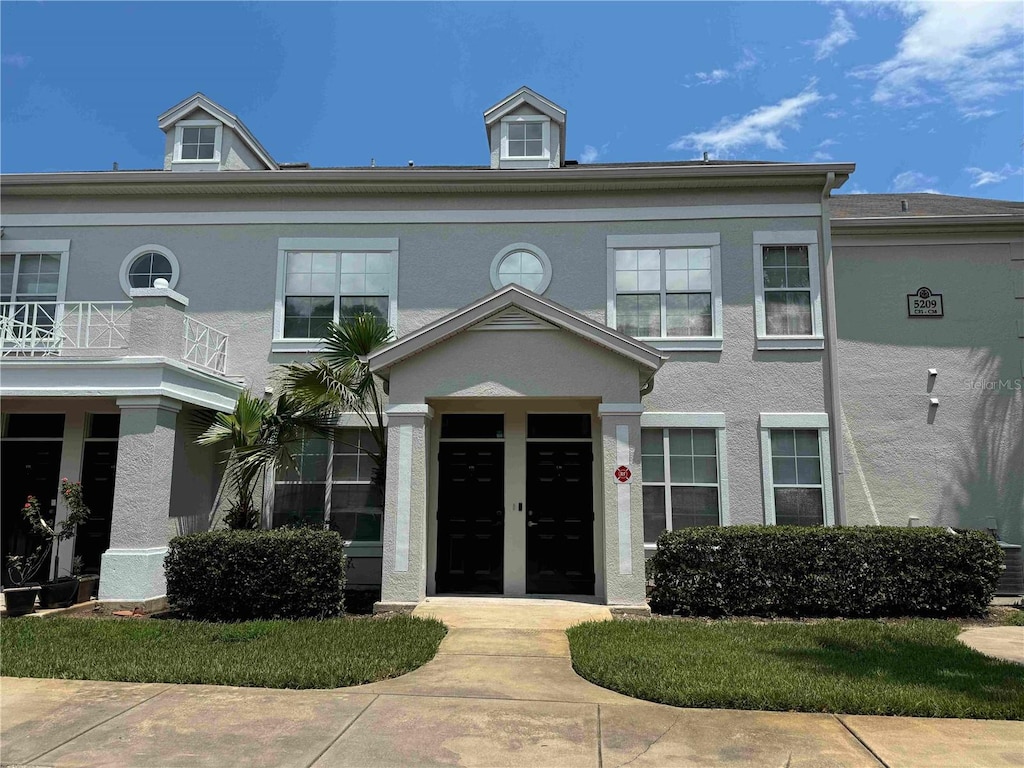 view of front of home with a balcony