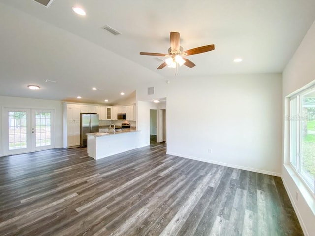 unfurnished living room with vaulted ceiling, sink, dark hardwood / wood-style flooring, ceiling fan, and french doors