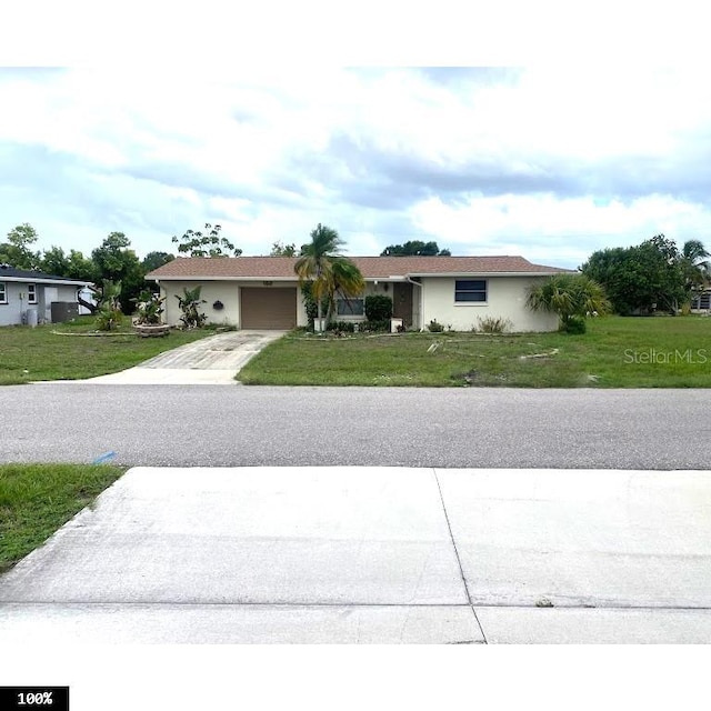 ranch-style home with a garage and a front yard