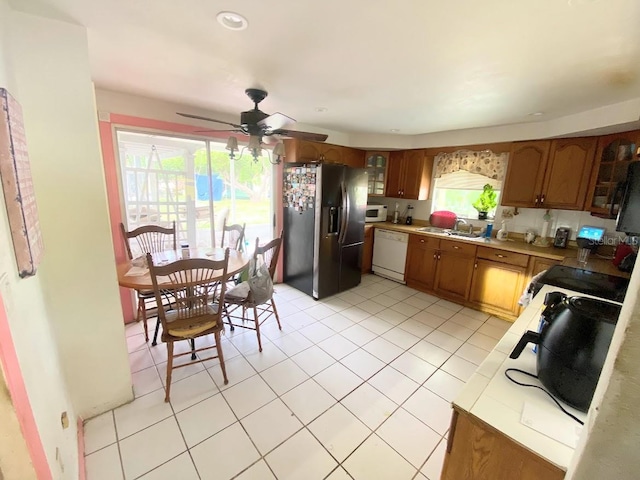 kitchen featuring sink, ceiling fan, white appliances, and light tile patterned floors