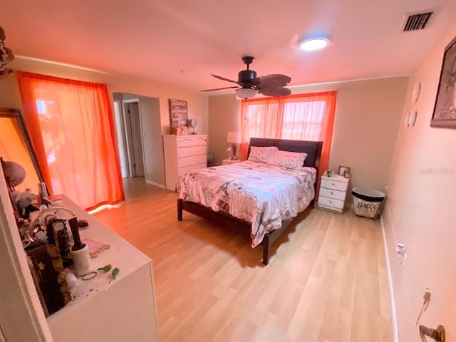 bedroom with ceiling fan and light hardwood / wood-style floors