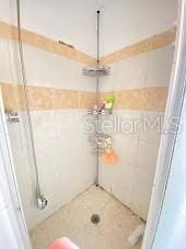 bathroom with tiled shower