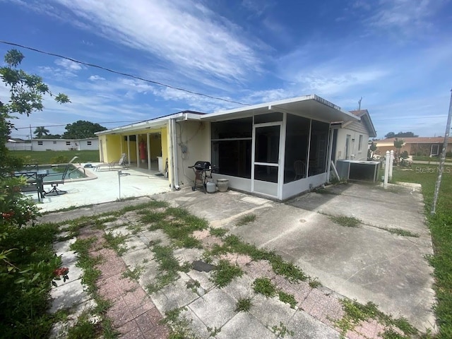 back of house featuring a patio and a sunroom