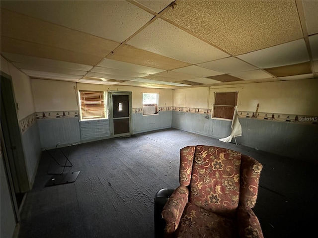 empty room featuring a drop ceiling and carpet floors