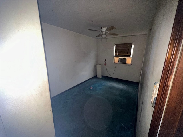 spare room with cooling unit and ceiling fan