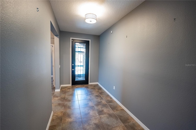 doorway featuring a textured ceiling