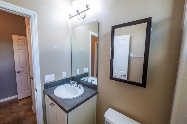 bathroom with toilet and vanity