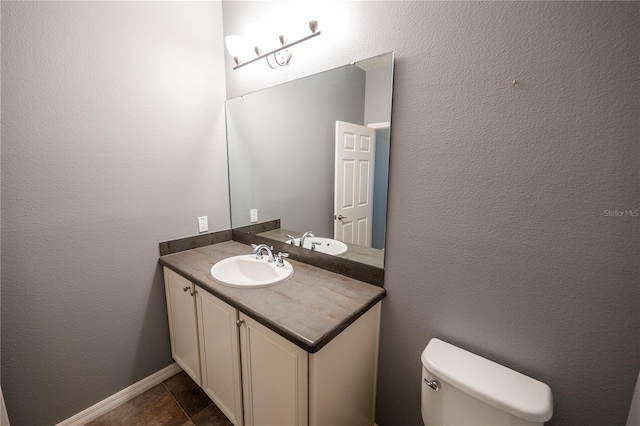 bathroom with tile patterned floors, toilet, and vanity