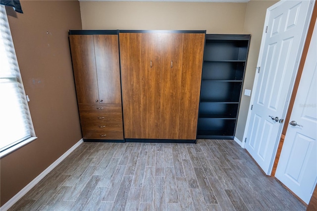 unfurnished bedroom with wood-type flooring