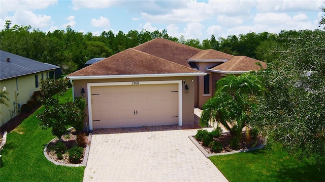 view of front of property featuring a garage and a front yard