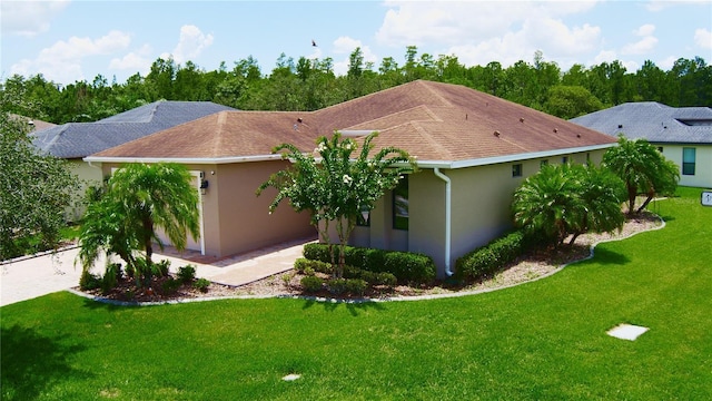 view of side of property with a lawn