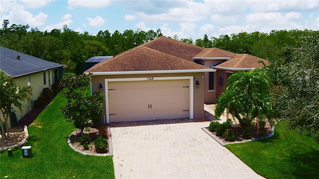 view of front of house featuring a garage, a front yard, and solar panels