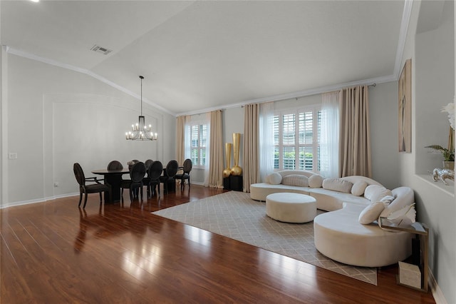 living room featuring ornamental molding, vaulted ceiling, hardwood / wood-style floors, and a notable chandelier