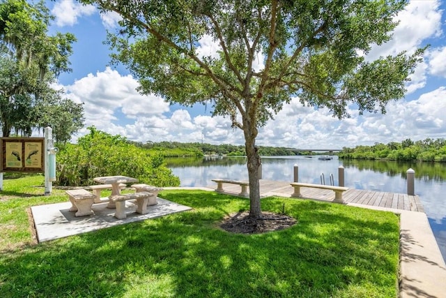 view of yard featuring a water view and a dock