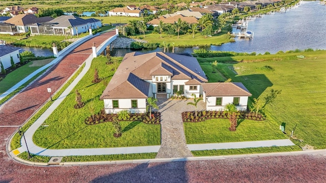 drone / aerial view featuring a water view and a residential view