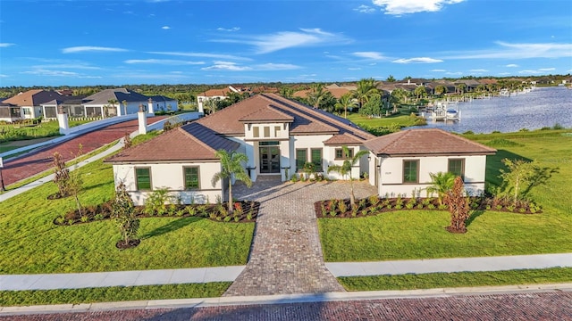 1529 Rio Vista Ter, Parrish, FL 34219 - mediterranean / spanish home with a residential view, a front lawn, stucco siding, a water view, and french doors