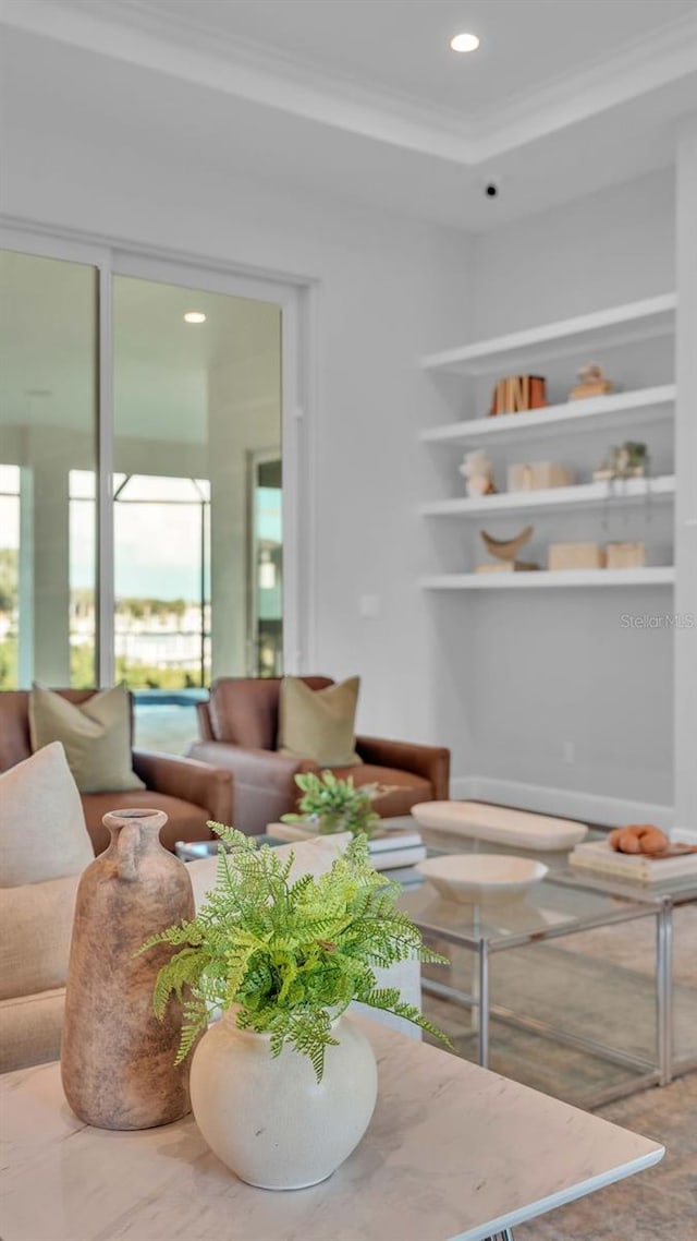 living room with plenty of natural light and crown molding