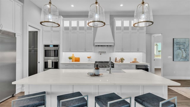 1529 Rio Vista Ter, Parrish, FL 34219 - kitchen featuring white cabinets, stainless steel appliances, a sink, and tasteful backsplash