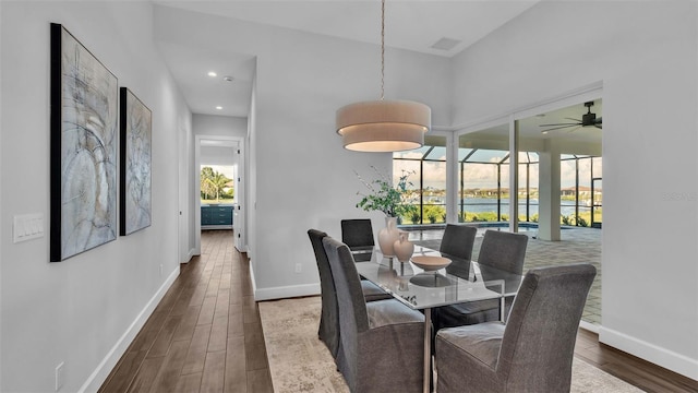 dining area featuring ceiling fan, dark hardwood / wood-style floors, and a healthy amount of sunlight